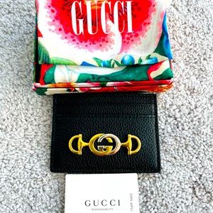- New Authentic Gucci wallet. Black leather, with gold and silver logo.